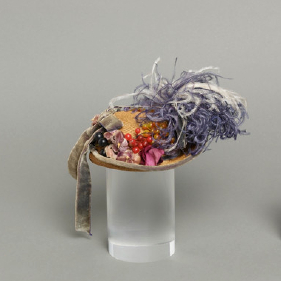 Mildred Blount miniature period hat; straw, braided, with silk velvet, ostrich feather, and plastic; 3 1/2 × 6 × 5 1/8 in. (8.89 × 15.24 × 13.02 cm); Gift of Marjorie St. Cyr (CR.75.2.23); courtesy of LACMA collections